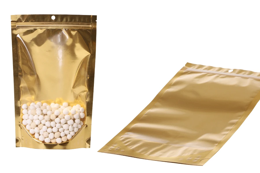 Aluminijumske DoyPack kesice sa zip zatvaranjem, zlatnom zadnjom i transparentnom prednjom stranom, ovalnim dnom i sa mogućnošću termo lepljenja 180x50x280mm – 100kom