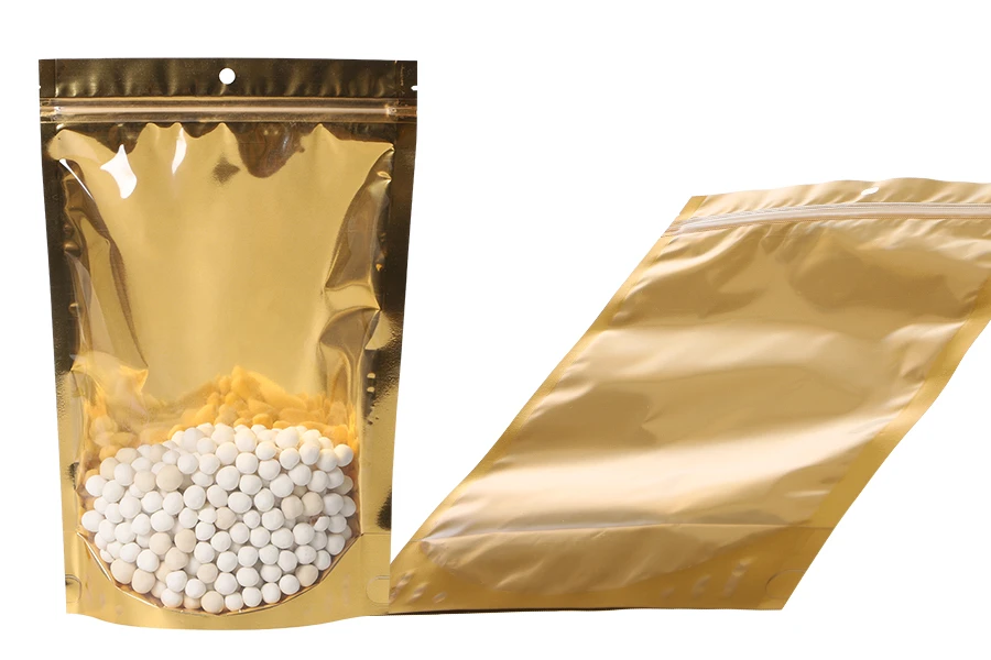 Aluminijumske DoyPack kesice sa zip zatvaranjem, zlatnom zadnjom i transparentnom prednjom stranom, ovalnim dnom i sa mogućnošću termo lepljenja 200x50x300mm – 100kom Aluminijumske DoyPack kesice sa zip zatvaranjem, zlatnom zadnjom i transparentnom prednjom stranom, ovalnim dnom i sa mogućnošću termo lepljenja 200x50x300mm – 100kom